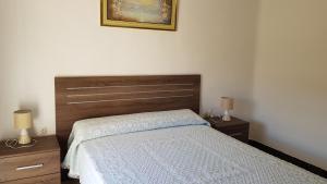 a bedroom with a bed and two night stands with lamps at Can Marti in Alfara de Carles