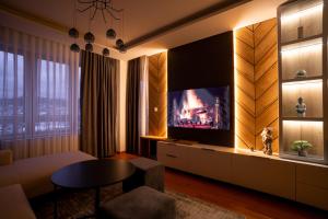 a living room with a flat screen tv on a wall at Apartman G8 Deluxe in Pale