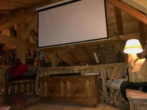 a large screen on the wall of a room at Chalet Alpage Proche Genève in Mégevette