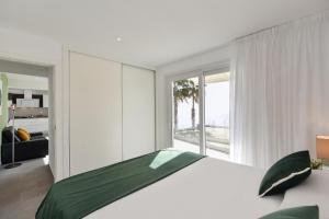 a bedroom with a large bed and a large window at Apartment Nueva Suecia CR715 by VillaGranCanaria in San Agustin
