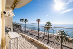 a balcony with a view of the beach at 3-Br apartment exceptional sea view by the beaches in Cannes