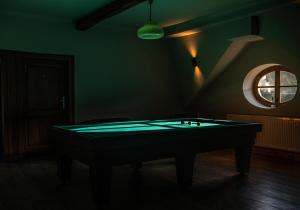 a dark room with a pool table in it at Château de la Chapelle in Anthisnes