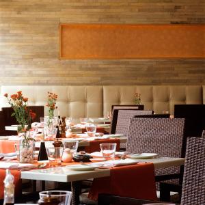 a dining room with tables and chairs with flowers on them at Trident Chennai in Chennai