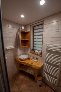 a bathroom with a sink and a mirror at Stodola Harrachov in Harrachov