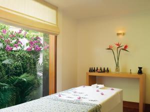 a room with a table and a window with flowers at Trident Chennai in Chennai