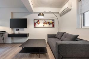 a living room with a couch and a table at Brand-New , Delux apt in Central Athens! in Athens