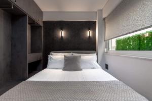 a bedroom with a white bed with a window at Brand-New , Delux apt in Central Athens! in Athens