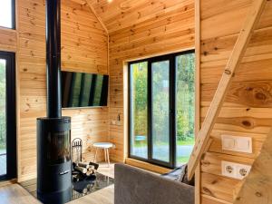 a log cabin with a fireplace in the living room at GUKHOUSE in Huklyvyy
