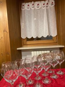 a bunch of wine glasses sitting on a red table at Maison Francey in Pré-Saint-Didier