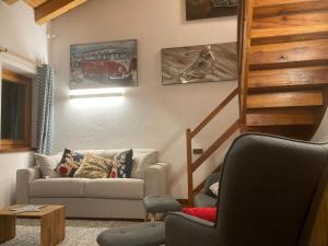 a living room with a couch and a car on the wall at Maison Francey in Pré-Saint-Didier +29 photos