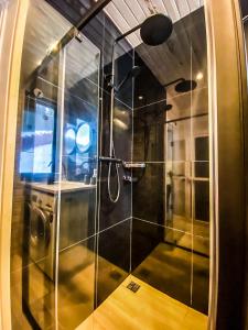 a bathroom with a shower with a glass door at GUKHOUSE in Huklyvyy +20 photos