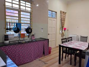 a kitchen with a table with a table cloth on it at Teratak Anakanda in Kuala Berang