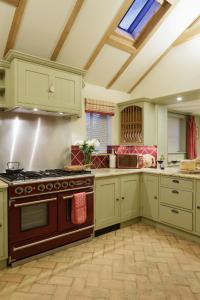 eine große Küche mit einem Herd mit Backofen in der Unterkunft Lavender Cottage in Thorndon