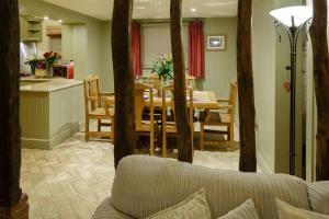 a kitchen and dining room with a table and chairs at Lavender Cottage in Thorndon