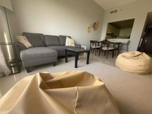 a living room with a couch and a table at Lovely 1 bedroom holiday home on the beach in Ras al Khaimah