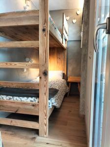a bedroom with bunk beds in a tiny house at Appartamento Campiglio 2 in Madonna di Campiglio