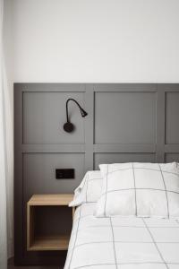 A bed or beds in a room at Exclusive Rooms in the Heart of the City