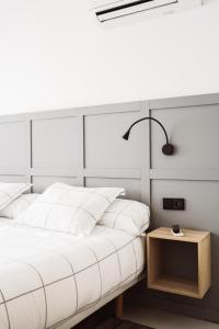 A bed or beds in a room at Exclusive Rooms in the Heart of the City