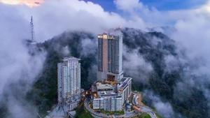 an aerial view of two tall buildings in the clouds at Atmosphere De Genting in Genting Highlands
