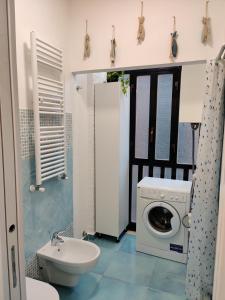 a bathroom with a washing machine and a sink at Casa Atena in Sperlonga