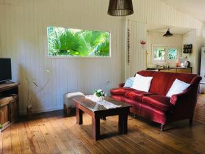 a living room with a red couch and a coffee table at Verde Lujan Delta in Tigre