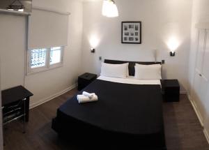
a bedroom with a bed and a lamp at Hotel Boutique Tremo Bellavista in Santiago

