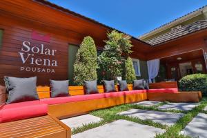 a bench in front of a building at Pousada Solar Viena in Gramado