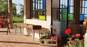 a porch with a bench and flowers on a patio at Campo dei Miracoli in Villa Lía