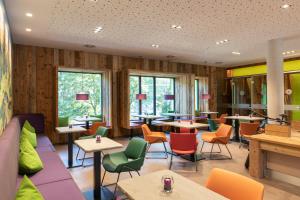 a restaurant with wooden walls and tables and chairs at Explorer Hotel Bad Kleinkirchheim in Bad Kleinkirchheim