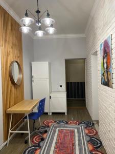 a room with a desk and a table and a rug at Apartment na Kirova 37 in Pyatigorsk