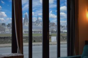 a view of a city from a window at "Gîte Le Relais Viennois" vue sur Loire & linge inclus in Blois