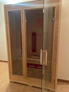 a glass cabinet with a phone in a room at Baita Fiorita in Mongiuffi Melia