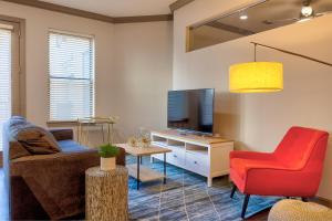 a living room with a couch and a tv at Kasa Central West End St Louis in Maryland Heights