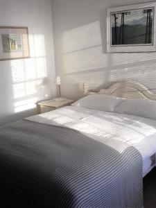 a bedroom with a white bed and a window at 38 Newtown in Bradford on Avon