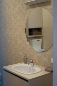 a bathroom with a sink and a mirror at Apartment in Druskininkai City Centre in Druskininkai +22 photos