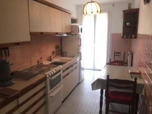 a kitchen with a stove and a sink and a table at Le Casone in Ajaccio