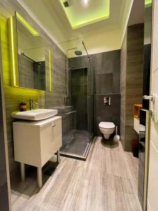 a bathroom with a sink and a shower and a toilet at The Bohemian Residence in Belgrade +16 photos