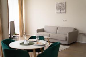 a living room with a couch and a table and chairs at Apartment in Druskininkai City Centre in Druskininkai