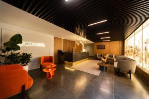 a lobby with orange chairs and a waiting room at SMALL HOTEL in Vinnytsya