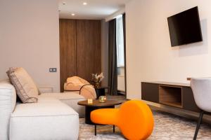 a living room with a couch and a table at SMALL HOTEL in Vinnytsya