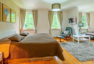 a bedroom with a large bed and a living room at Landgasthof Geiersmühle in Vielbrunn