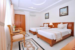 Tan Hoang Long Hotel tesisinde bir odada yatak veya yataklar