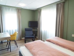 Postel nebo postele na pokoji v ubytování Hotel Workum
