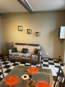 a living room with a couch and a glass table at maison des corbieres in Conilhac-Corbières