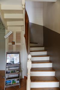 a staircase in a home with a white stair case at LADOREPONTAISE in Pondaurat