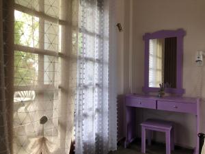 a room with a window with a sink and a mirror at Blue Garden Inn in Fourka +61 photos