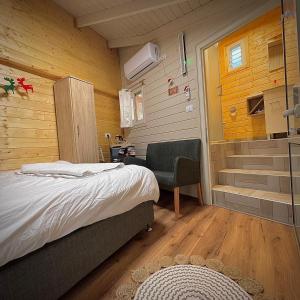 a bedroom with a bed and a walk in shower at Vida Bhermon 2, one small wooden cabin in Majdal Shams