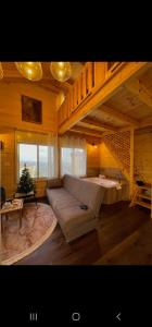 a living room with a couch and a christmas tree at Vida Bhermon 1, one wood Cabin in Majdal Shams