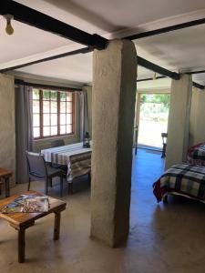 a living room with a table and a room with at Douglas Drift Cottages in Underberg