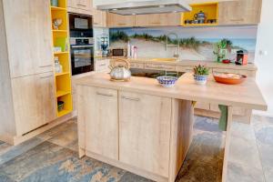 a kitchen with a wooden island with a sink at Haus Marianne in Breege